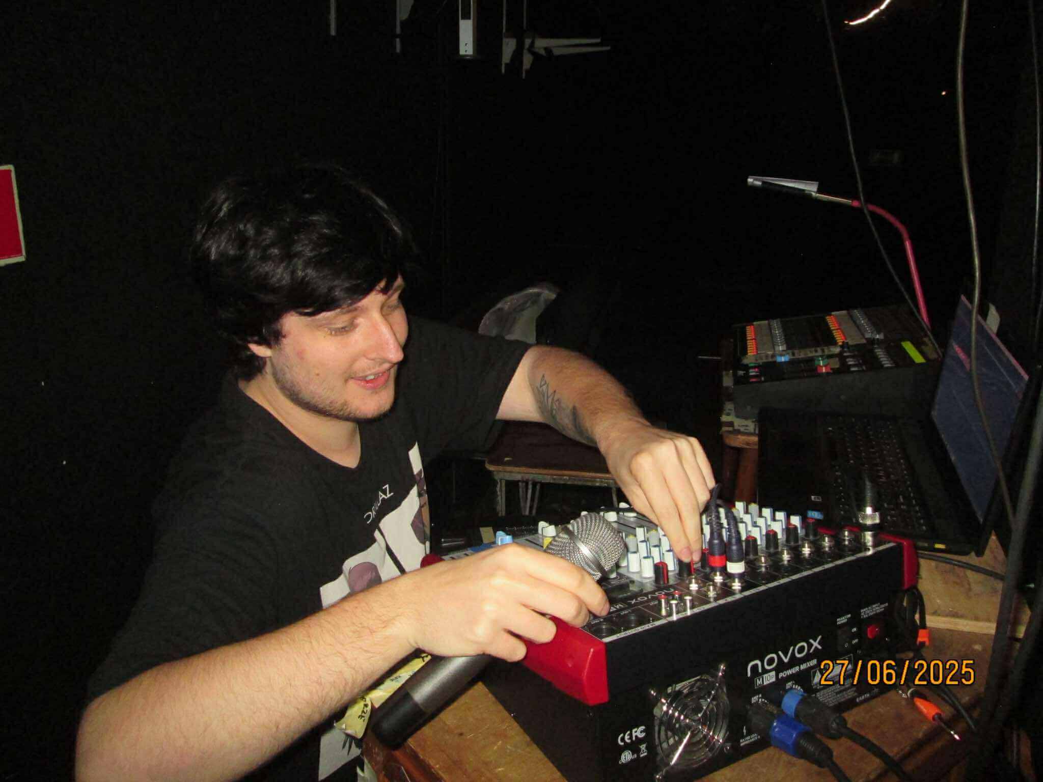 Na zdjęciu mężczyzna, obsługujący konsoletę dźwięku z dużą ilością pokreteł